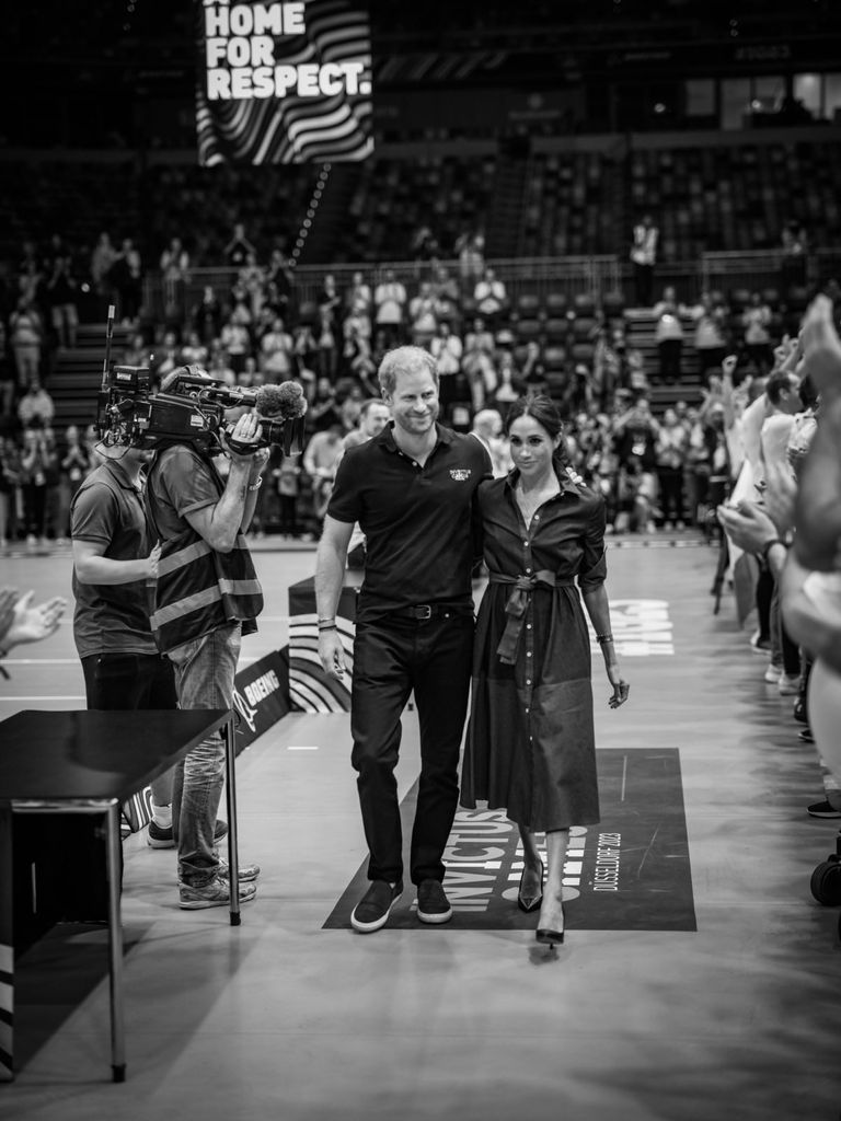 Prince Harry and Meghan Markle walking through Invictus Games court