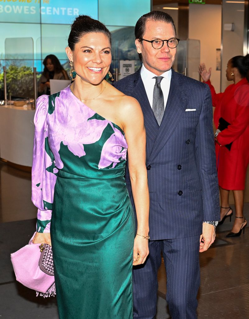 Crown Princess Victoria in green and purple dress smiling with daniel 