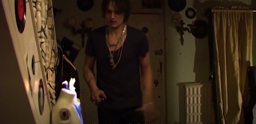 Pete Doherty lighting a fire inside his home