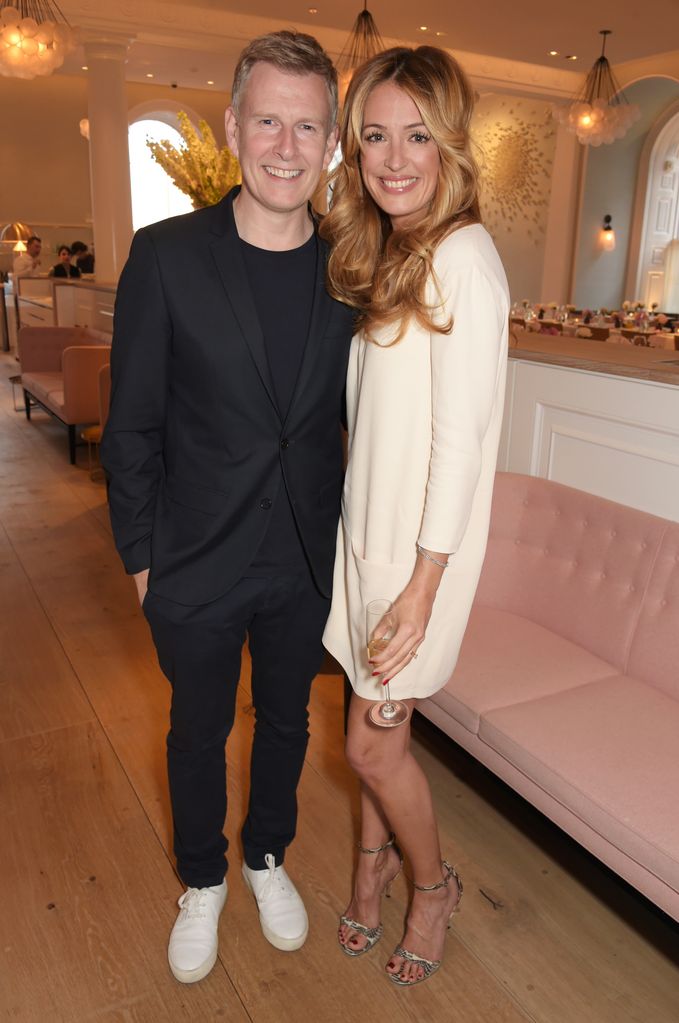Patrick Kielty in a suit and Cat Deeley in a white mini dress and heels