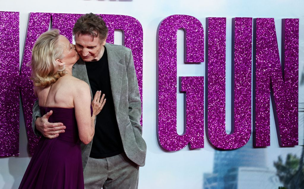 US actress Pamela Anderson (L) and British actor Liam Neeson (R) pose on the red carpet upon arrival for the UK Premier of "Naked Gun" in Leicester Square, central London, on July 22, 2025.