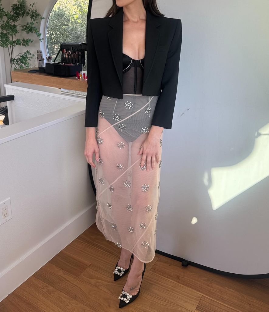 neck downwards shot of Ashley Greene's naked skirt bedazzled with floral applique