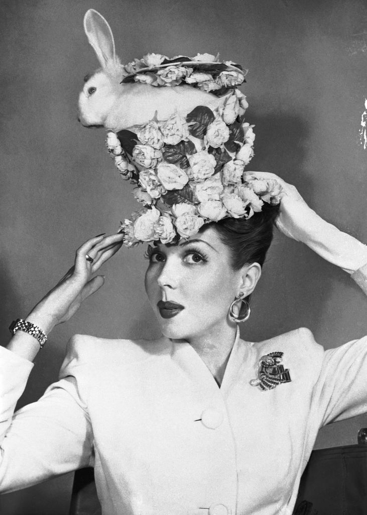 Ann Miller wears an elaborate floral Easter bonnet with a live rabbit tucked inside. Blurb: