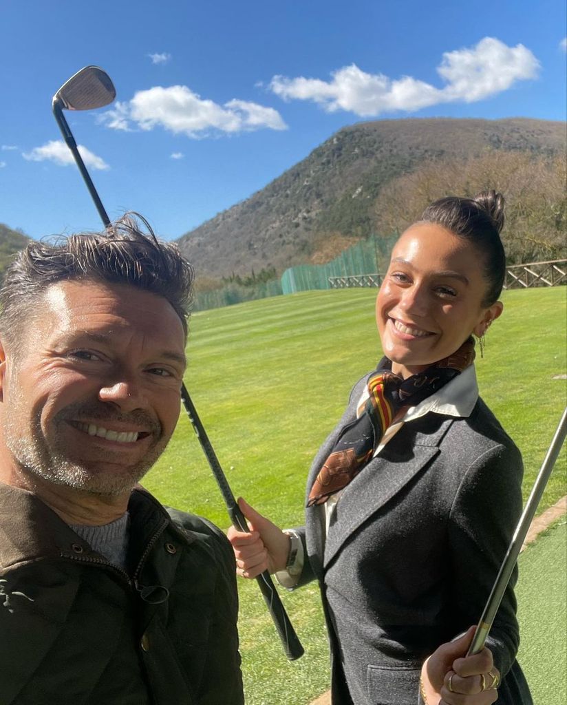 Ryan Seacrest and his girlfriend Aubrey pose for a selfie while golfing