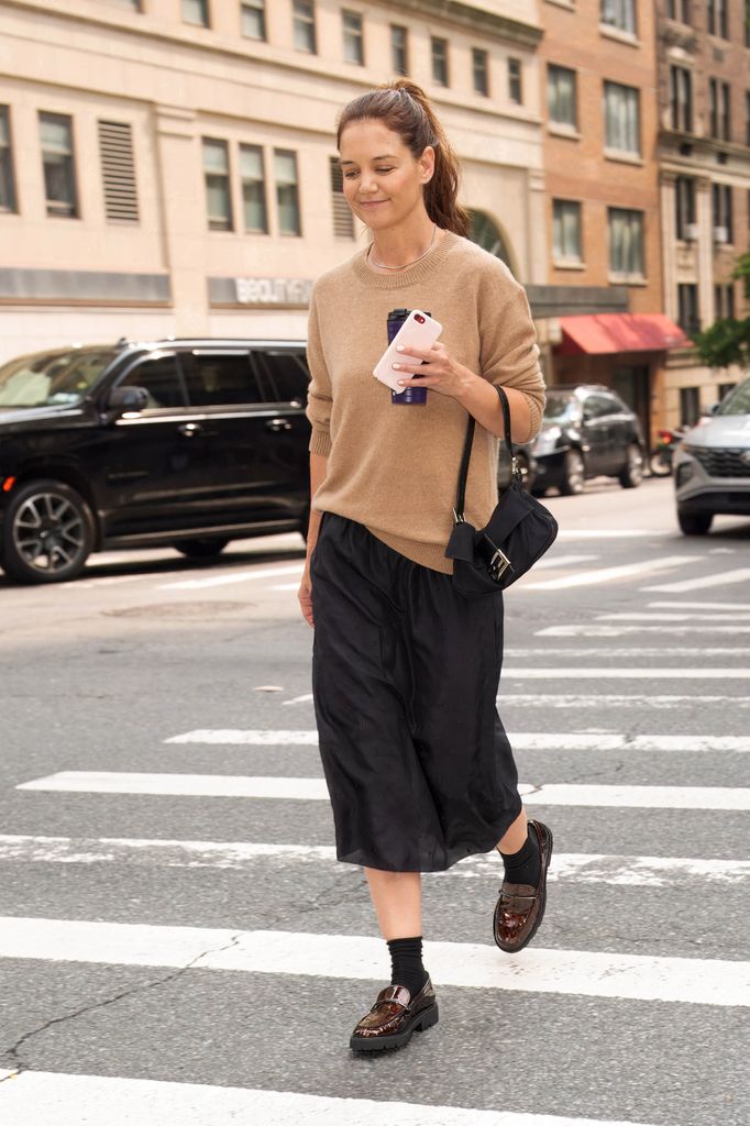Katie Holmes in beige sweater and black skirt walking in NYC