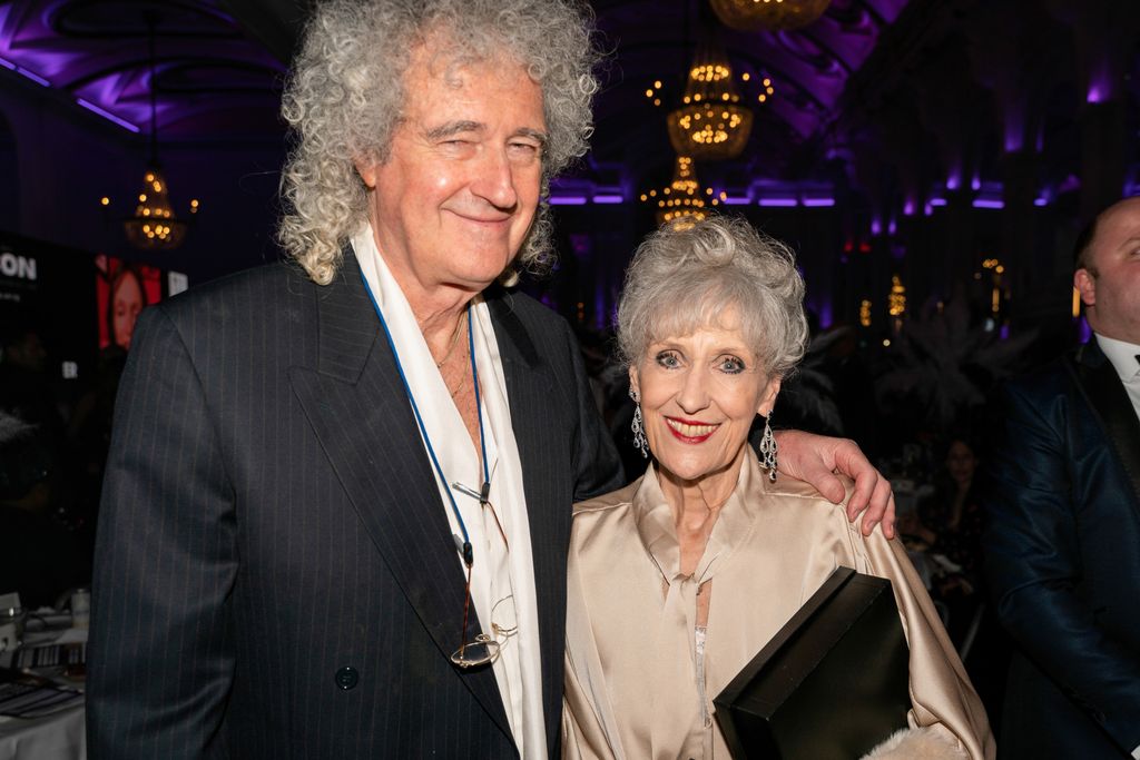 Brian May with his arm around Anita Dobson