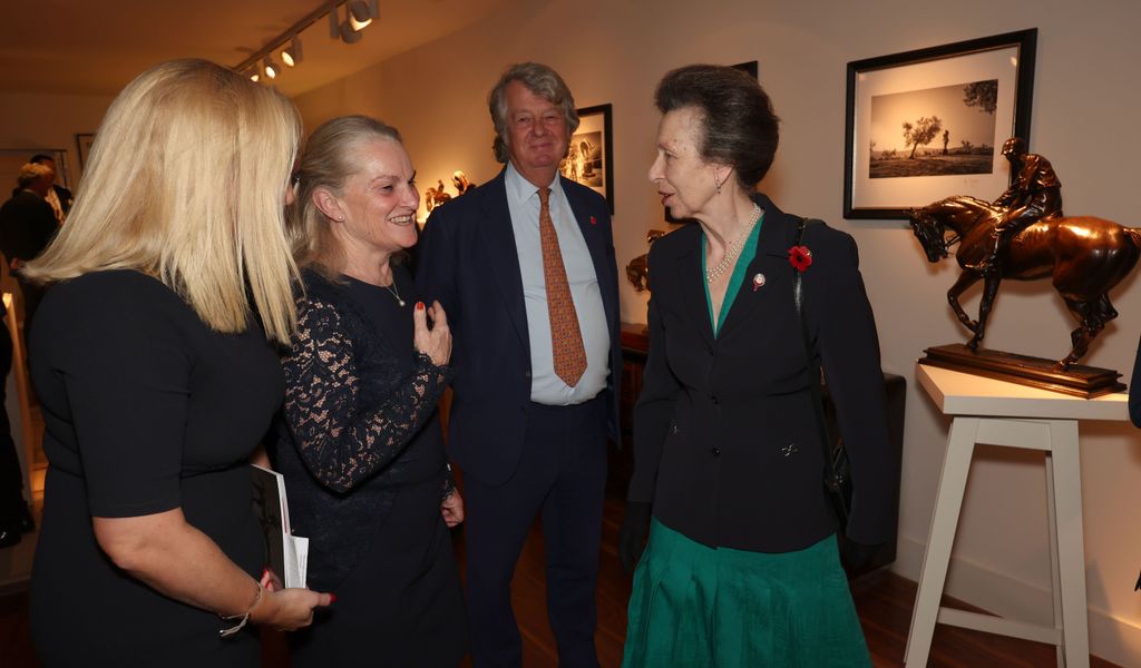 Princess Anne chatting to three other people at an event 