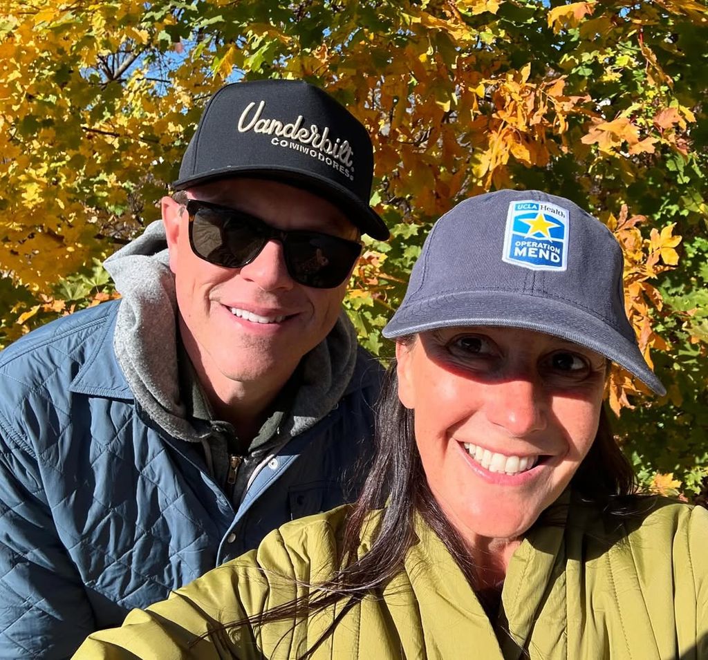 Willie and Christina smiling matching baseball caps