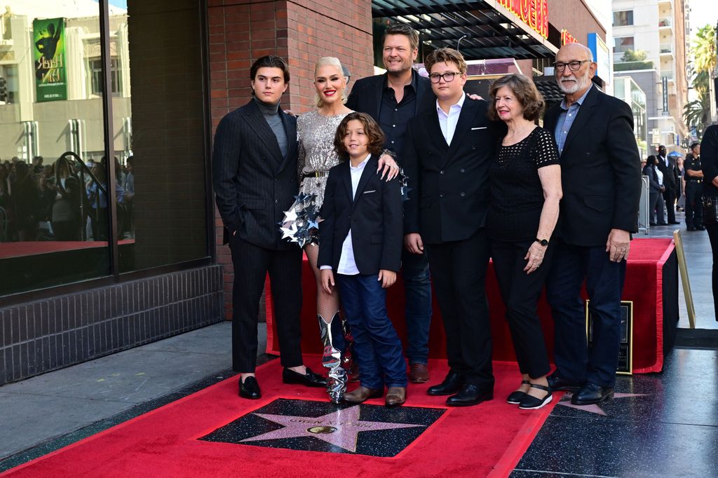 US singer Gwen Stefani, her husband Blake Shelton  and family members pose next to her Hollywood Walk of Fame Star on Hollywood, California, on October 19, 2023.