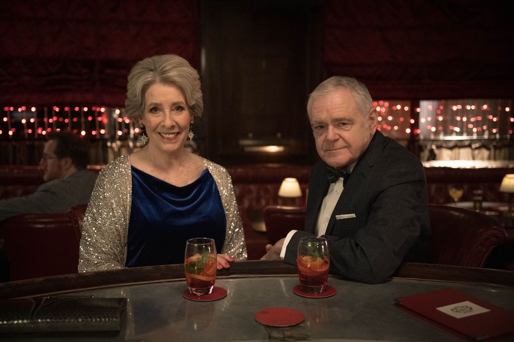 woman and man sitting at bar