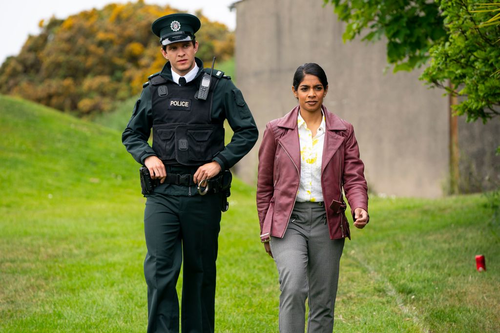 police officer and woman walking on field