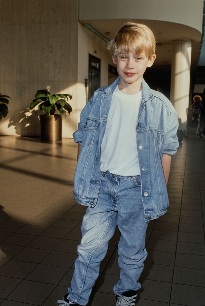 Macaulay Culkin in a denimn jacket and jeans