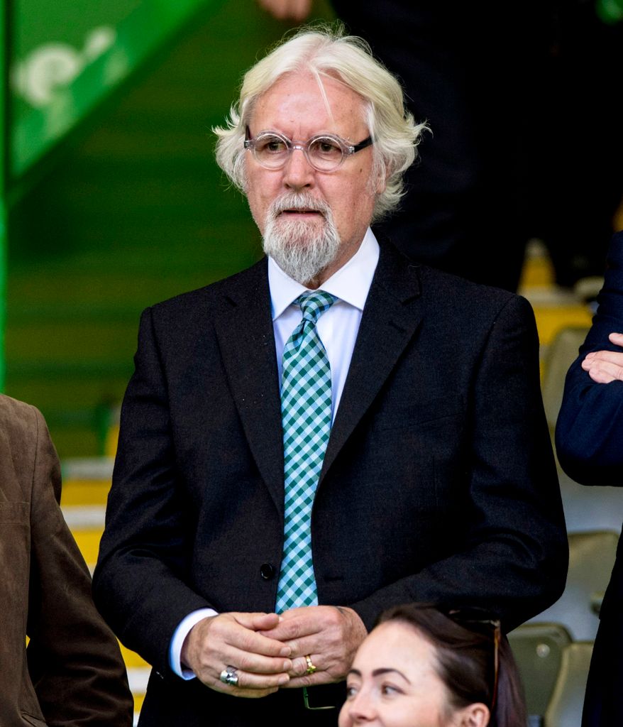 Billy Connolly in a dark suit