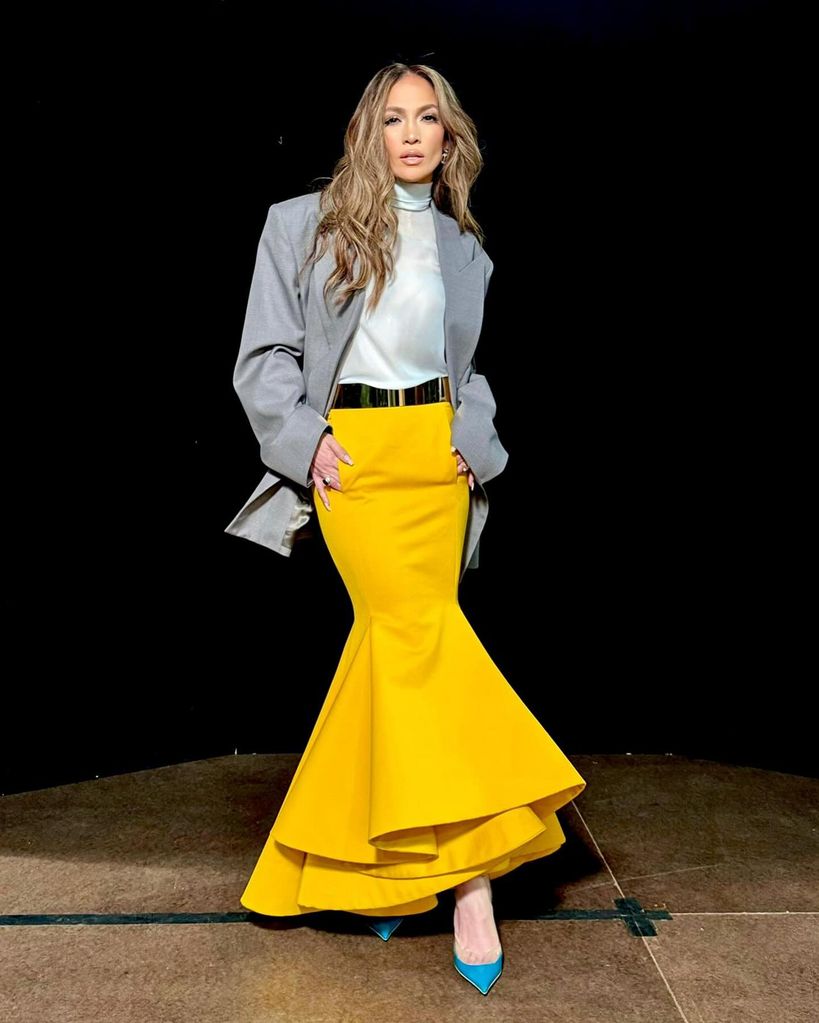JLo in yellow skirt and grey blazer
