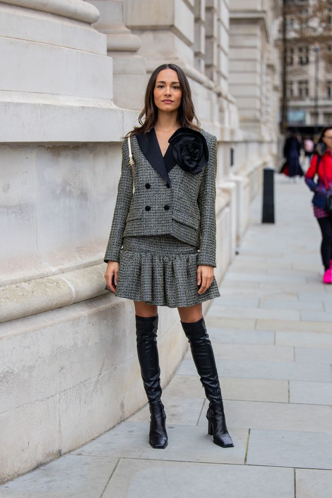  Yasmin Hass wears grey blazer, pleated skirt, black over knees boots outside Huishan Zhang during London Fashion Week February 2024 on February 16, 2024 in London, England. (Photo by Christian Vierig/Getty Images)