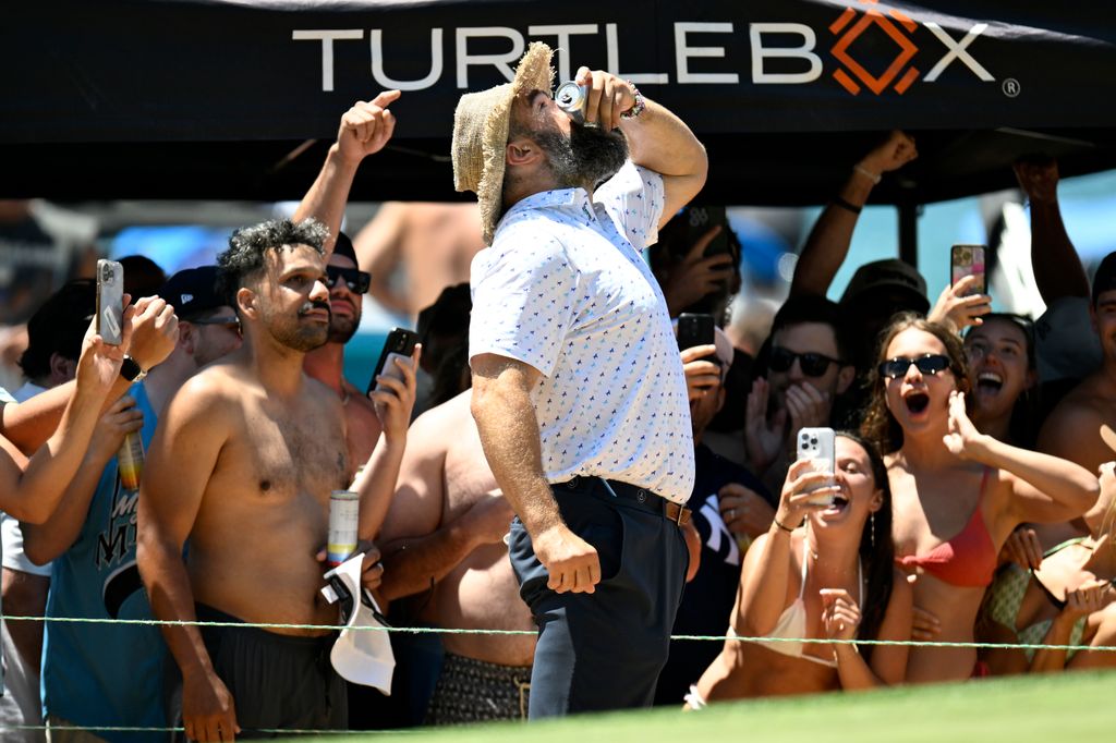 Jason Kelce has a drink handed to him by spectators on the 17th hole during the second round of the American Century Championship at Edgewood Tahoe Golf Course on July 12, 2025 in Stateline, Nevada