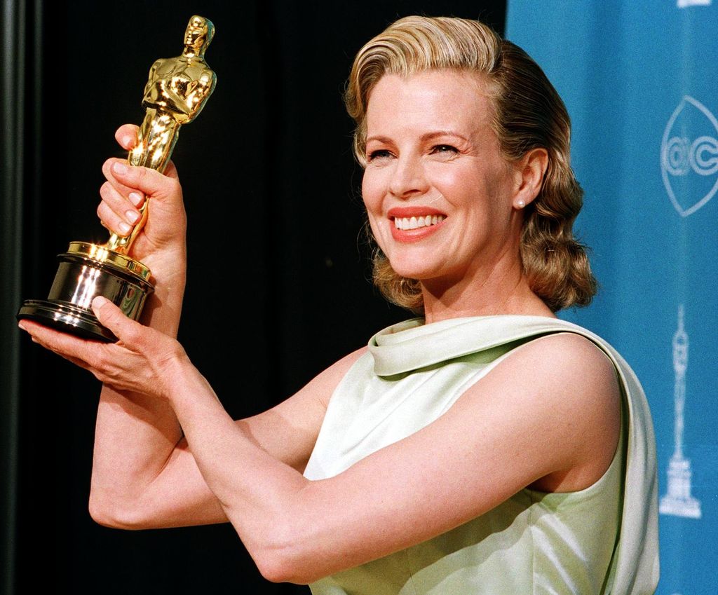 Kim Basinger holds up her Oscar for Best Supporting Actress  for her role in "L.A. Confidential" during the 70th Annual Academy Awards 