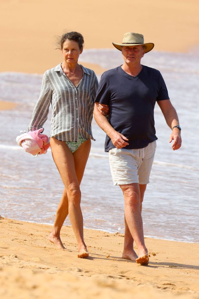 The lawyer was joined by her husband Craig as they walked along the beach