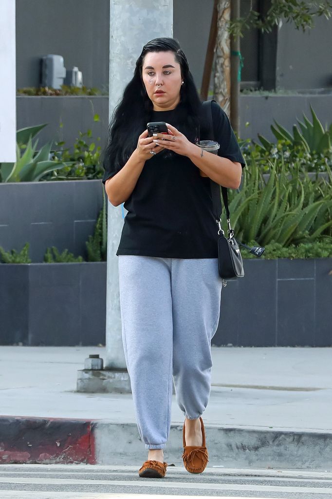 Amanda Bynes texting as she walks around Hollywood in a black top