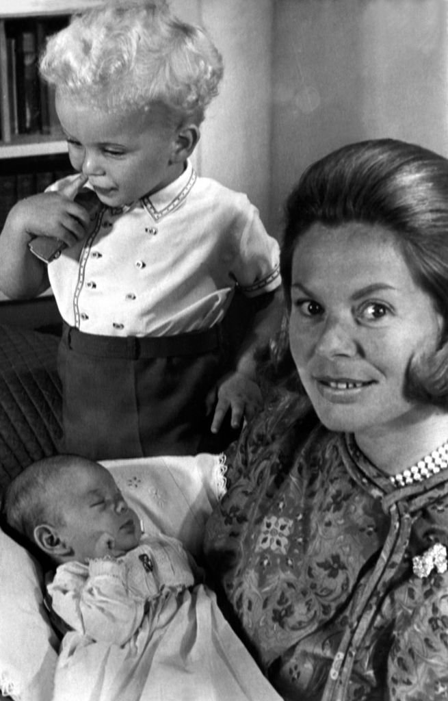 The Duchess of Kent pictured with her new baby daughter Lady Helen Windsor, sleeping soundly and son Earl of St Andrews at Coppins