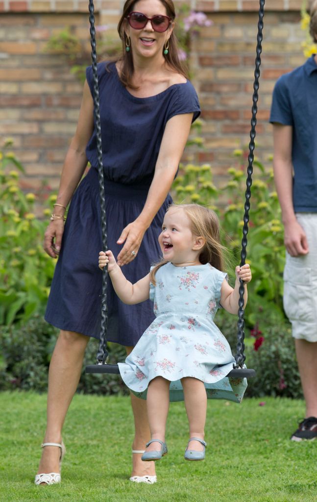 Crown Princess Mary pushes her daughter Princess Josephine on a swing