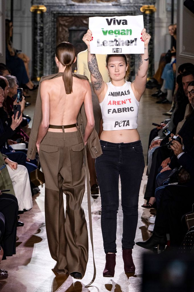 Protestors appear on the runway during the Victoria Beckham Ready to Wear Fall/Winter 2024-2025 fashion show as part of the Paris Fashion Week 