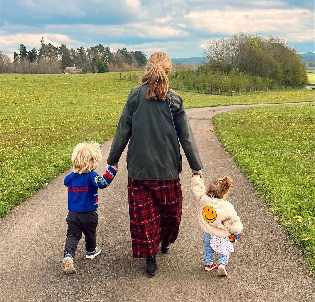Carrie Johnson walking hand in hand with her children