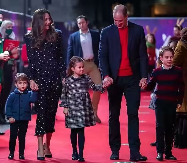 prince and princess of wales with their three children on red carpet