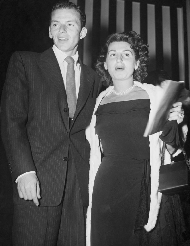 (Original Caption) With Hollywood film stars after dark...Frank Sinatra and his own wife, Nancy, about to enter Ciro's night club in Hollywood, where film stars sometimes go to night clubs with their own wives.