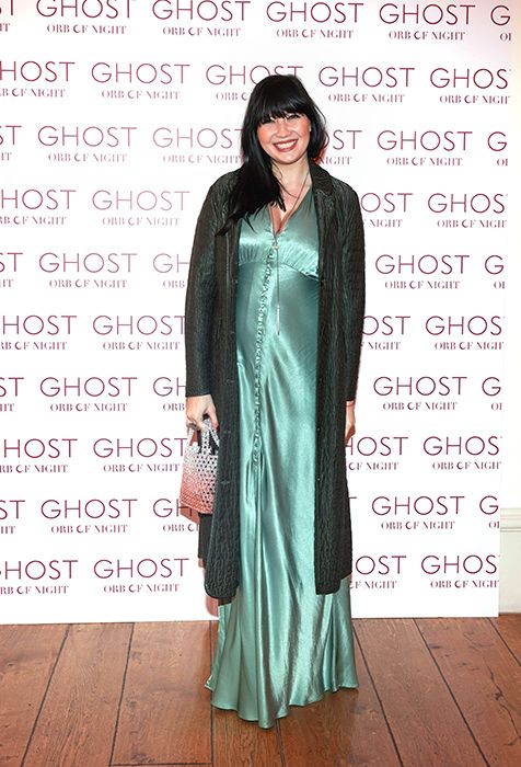 Daisy Lowe showing off her baby bump in a green dress at a Ghost event