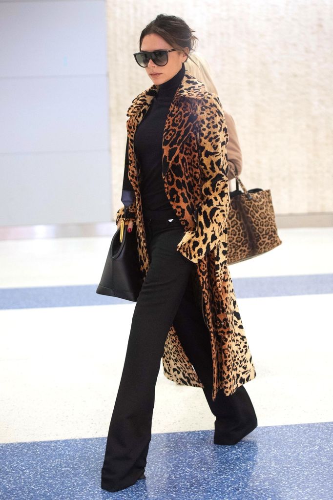  Victoria Beckham arrives at JFK airport wearing her leopard print split sleeve coat from the Victoria Beckham collection that retails for around £3000