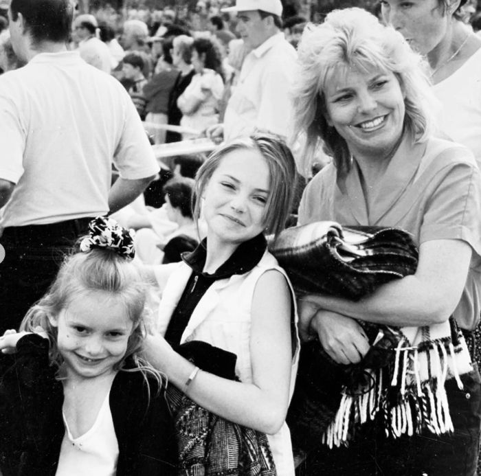 Black-and-white photo of two daughters with their mother