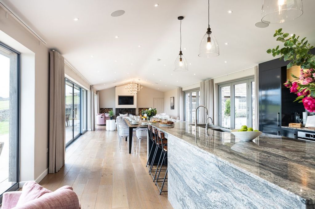 Open plan dining room kitchen with floor to ceiling windows 