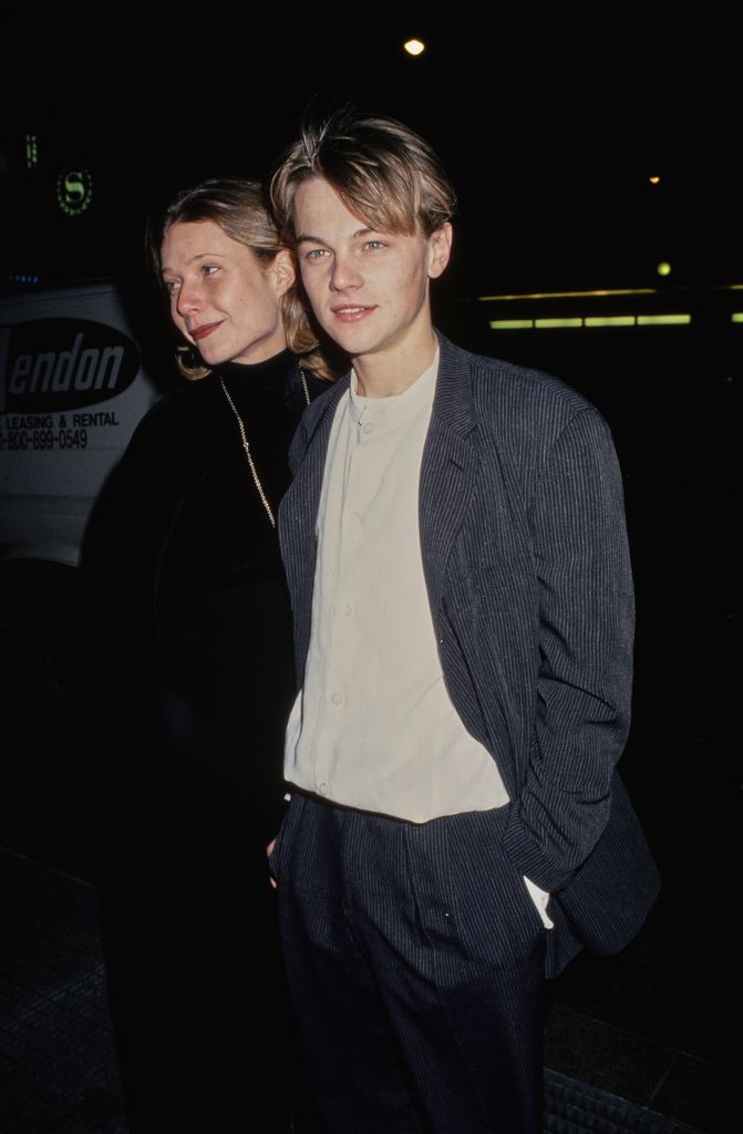 Gwyneth Paltrow, wearing a black turtleneck outfit with a long necklace, and American actor Leonardo DiCaprio, who wears a striped suit of a white collarless shirt, attend the 65th Annual National Board of Review of Motion Pictures Awards at the Equitable Center in Midtown Manhattan, New York City, New York, 28th February 1994. (Photo by Vinnie Zuffante/Getty Images)