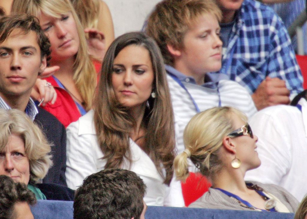 Kate Middleton in a white coat next to her brother James