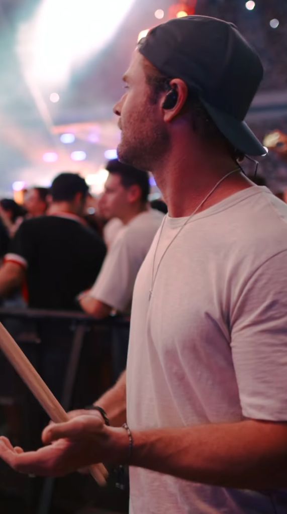 Chris Hemsworth warms up before playing drums for Ed Sheeran