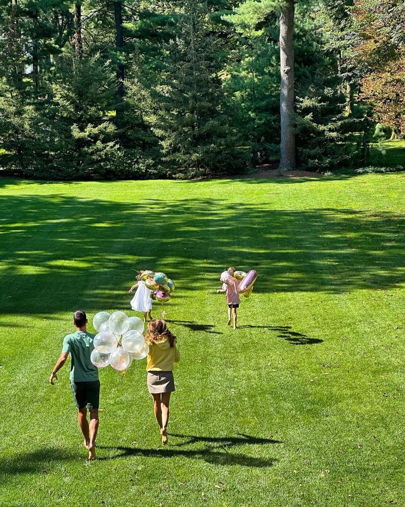 Novak, Jelena, Stefan and Tara Djokovic running down the grass holding balloons in photo shared on Instagram