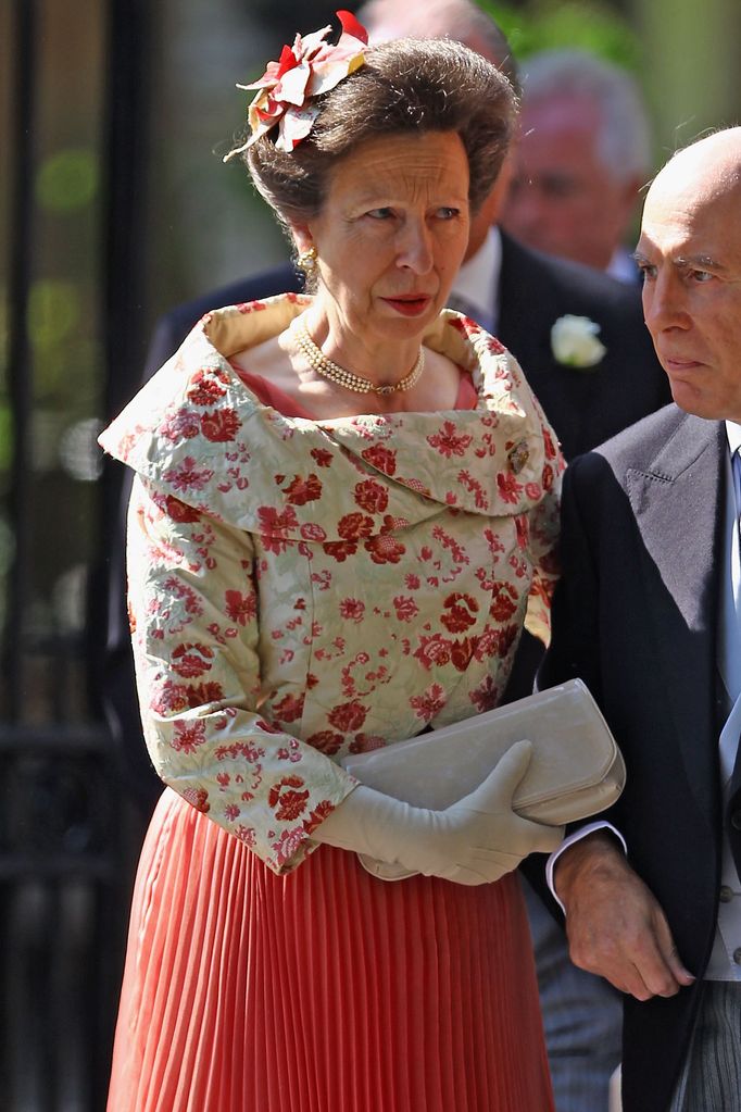 Princess Anne in a pleated coral dress at Zara Tindall's wedding