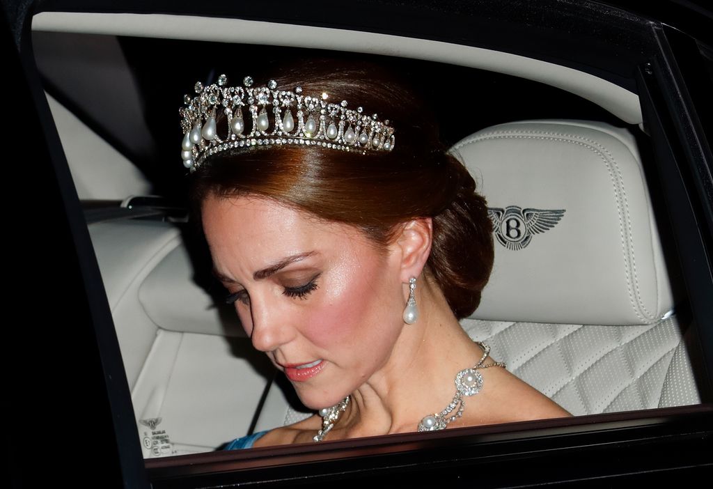 A photo of Kate Middleton sitting in a Bentley wearing a tiara 