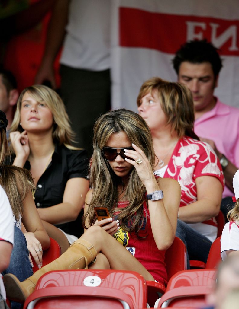 Victoria Beckham (C), wife of England Captain David Beckham, and Coleen McLoughlin (L), girlfriend of Wayne Rooney, attend the FIFA World Cup Germany 2006 Group B match between England and Trinidad and Tobago at the Frankenstadion on June 15, 2006 in Nuremberg, Germany. 