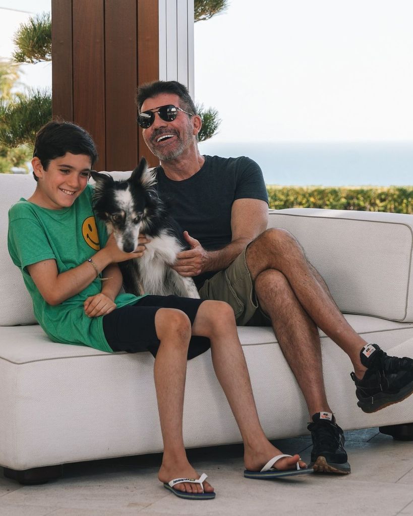 Simon Cowell and his son cuddling a dog