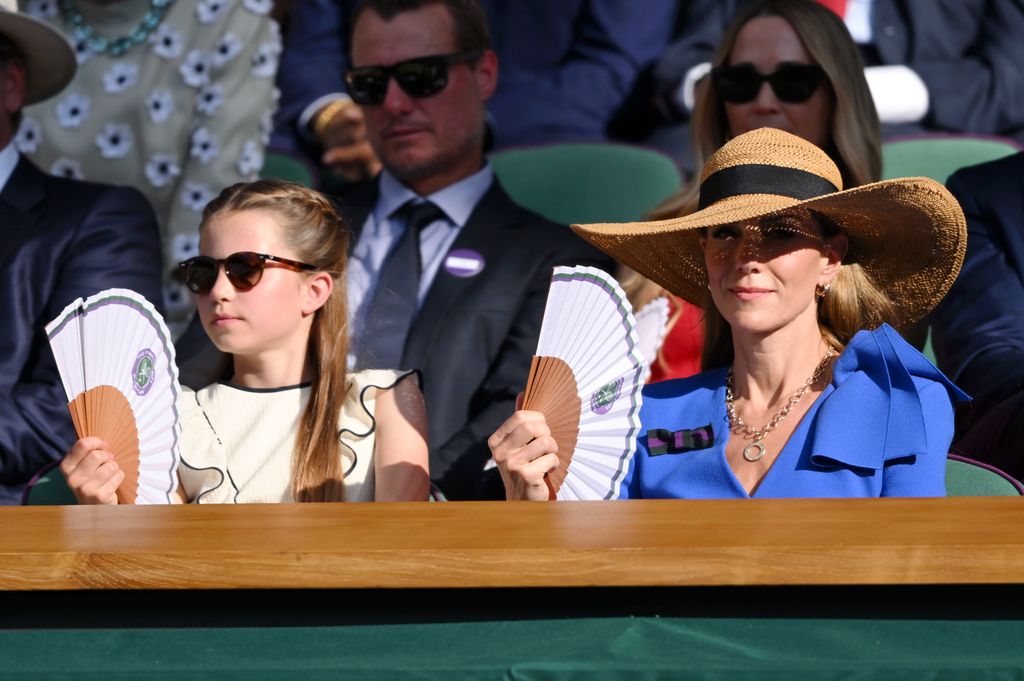 Kate and Charlotte waving fans