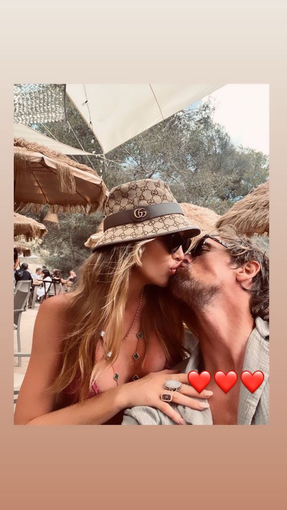 Abbey Clancy and Peter Crouch kissing on holiday