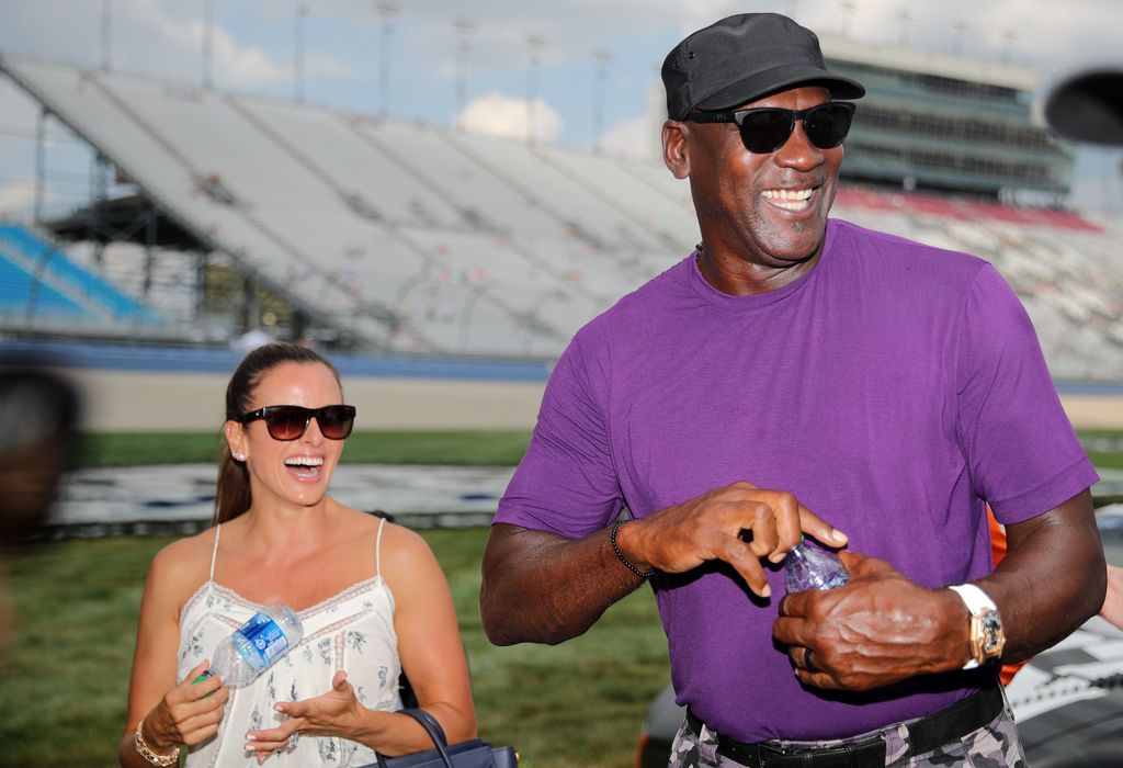 LEBANON, TENNESSEE - JUNE 25: NBA Hall of Famer Michael Jordan and co-owner of 23XI Racing walks the grid with his wife, Yvette Prieto during qualifying for the NASCAR Cup Series Ally 400 at Nashville Superspeedway on June 25, 2022 in Lebanon, Tennessee. (Photo by Meg Oliphant/Getty Images)