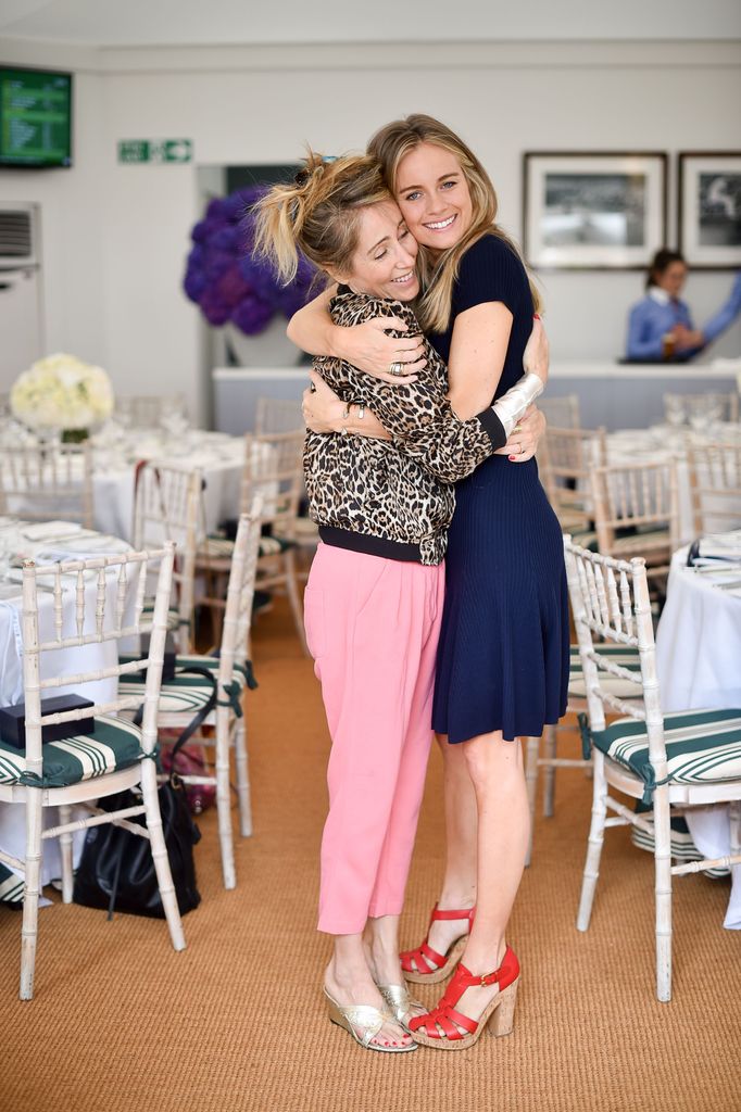 two woman cuddling in colourful clothing