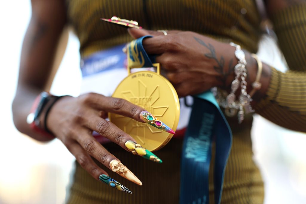 A detail of Sha'Carri Richardson's nails with her gold medal after competing in the women's 100 meter final on Day Two of the 2024 U.S. Olympic Team Track & Field Trials