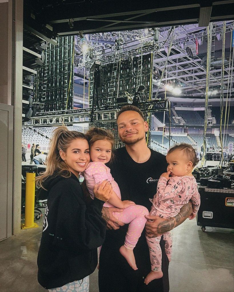 Kane Brown and Katelyn pose for a picture with their two girls