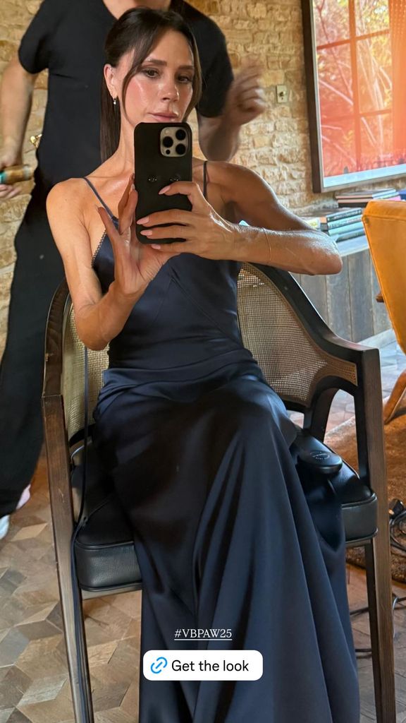 A photo of Victoria Beckham wearing a navy blue dress 