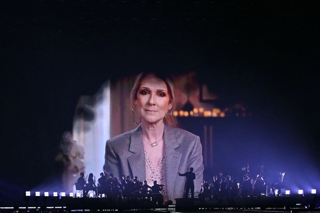 A screen shows Canadian singer Celine Dion giving a recorded message during the first semi-final of the Eurovision Song Contest 2025
