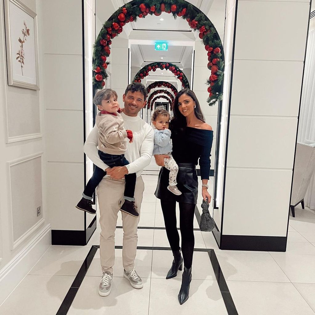 Ryan Thomas and Lucy Mecklenburgh with their kids in front of a flower arch